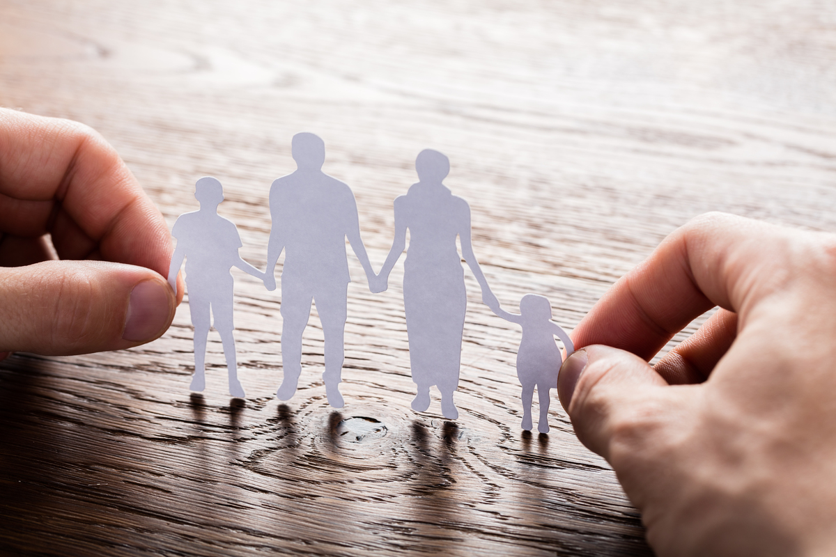 mp19359974-person-holding-paper-cut-of-family.jpg