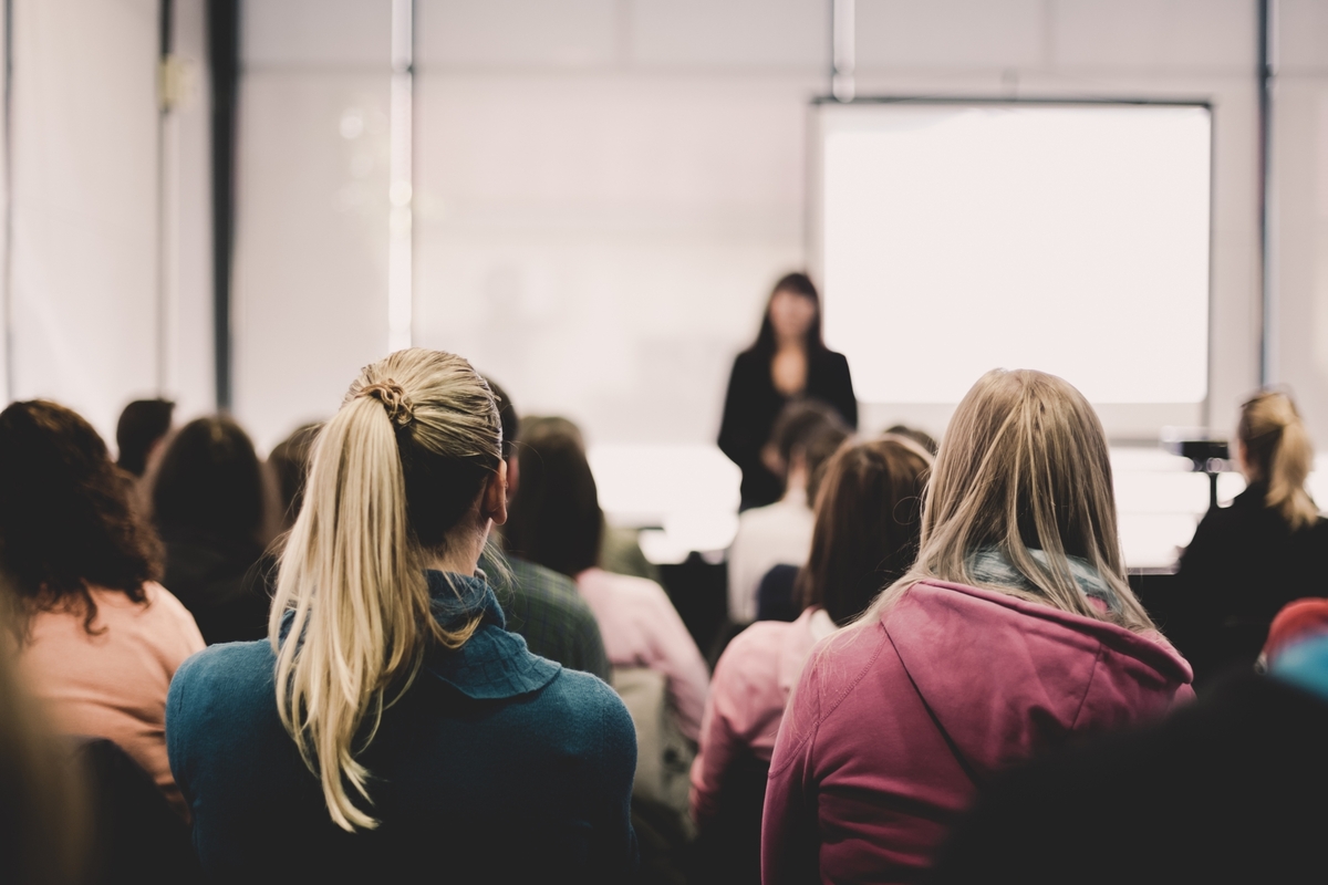 50043198-female-speaker-giving-presentation-in-lecture-hall-at.jpg