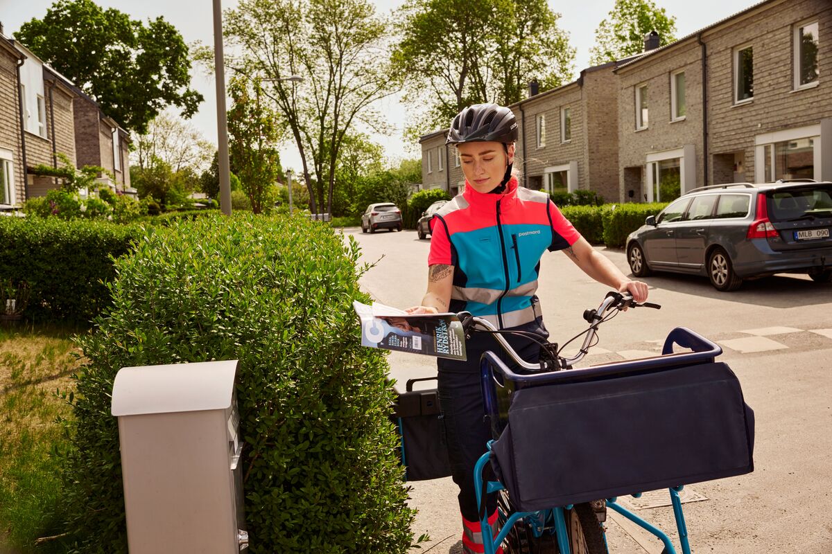 Woman on bike delivering mail.jpg