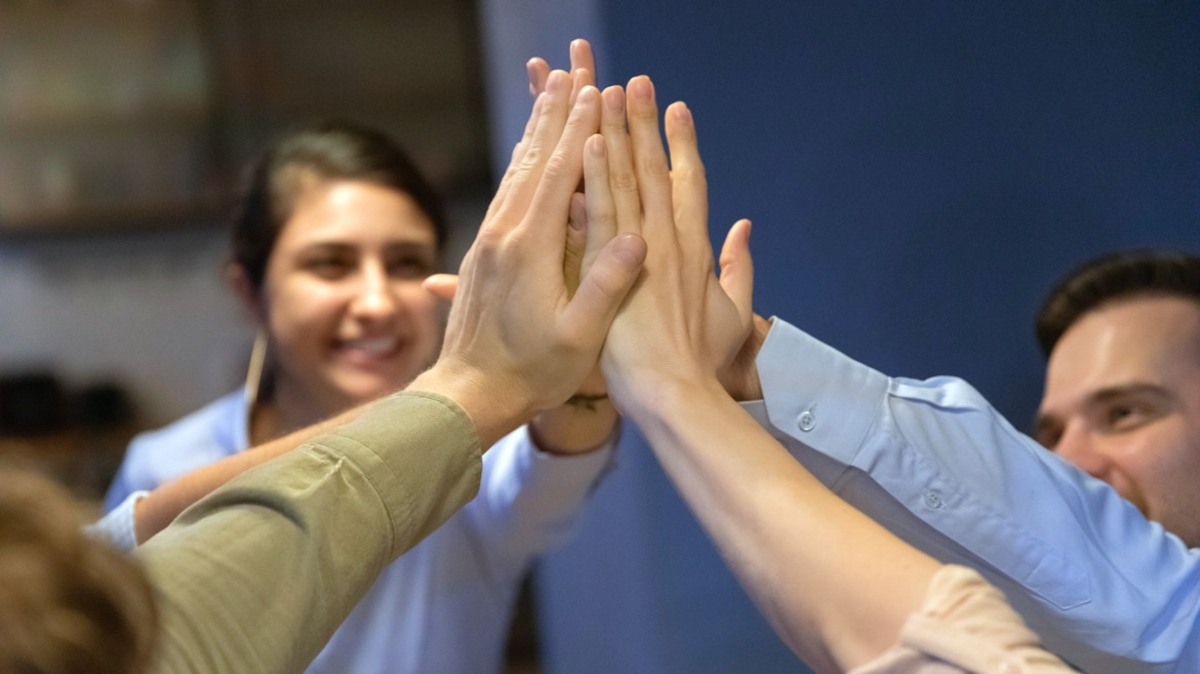 44009239-excited-employees-give-high-five-at-meeting-varbi.jpg