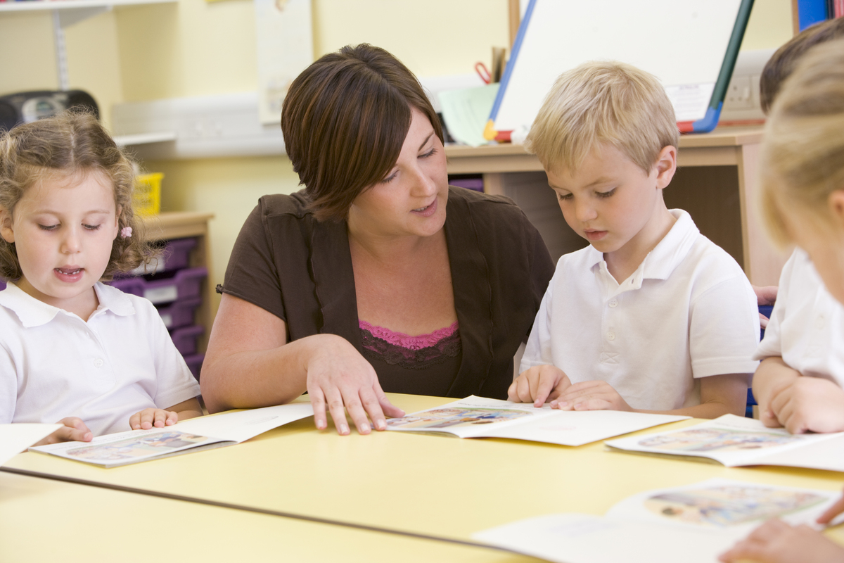 2127564-schoolchildren-and-their-teacher-reading-in-a-primary-class.jpg