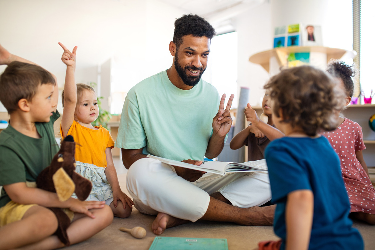 Förskola - Pedagog sitter i ring med barnen.
