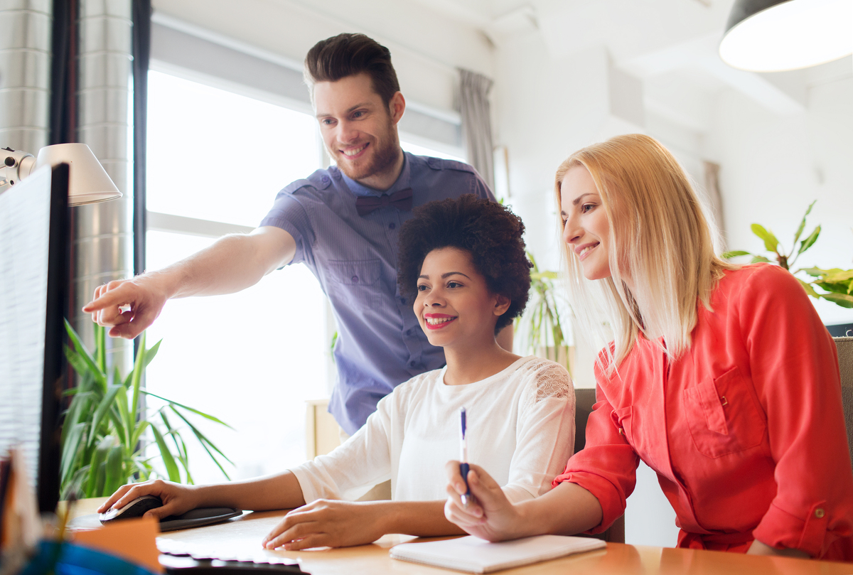 Happy-creative-team-with-computer-in-office.jpg